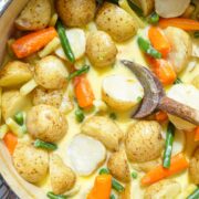 A pot filled with fresh vegetables in a cream base.