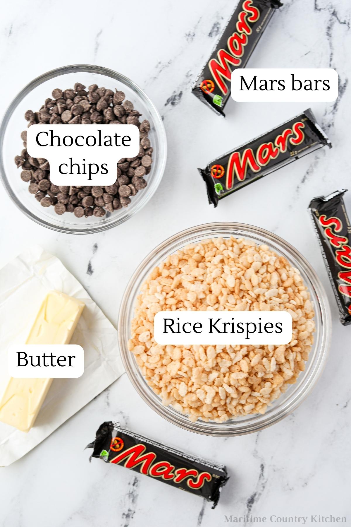 The ingredients needed to make Mars Bar Slice: Rice Krispies, Mars bars, chocolate chips, and butter.