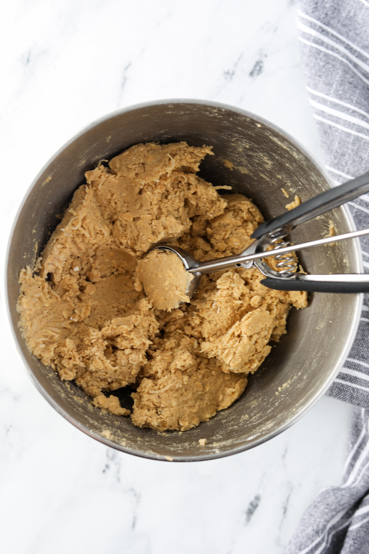 Scooping cookie dough with a cookie scoop.