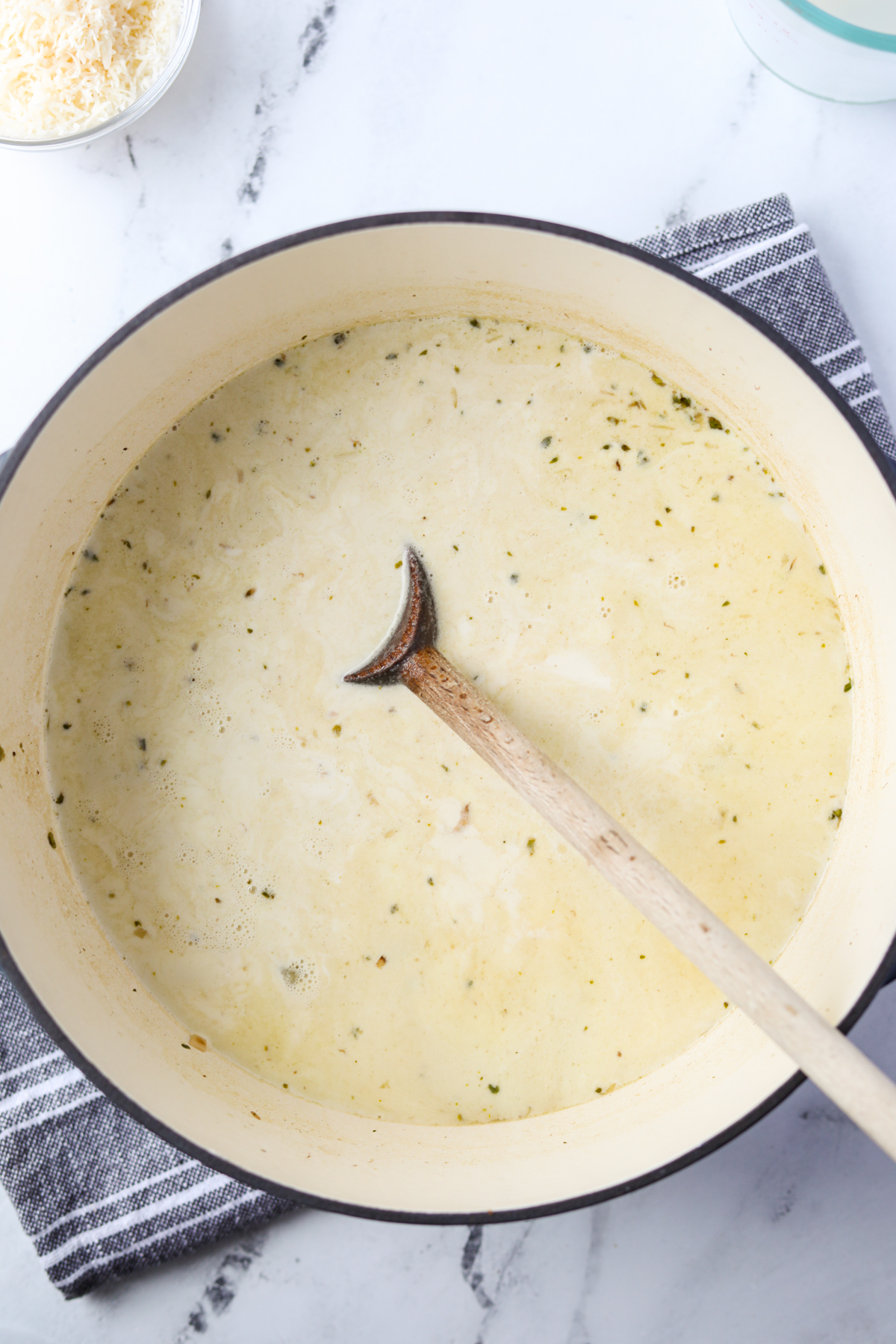 A Dutch Oven with a cream soup in it.