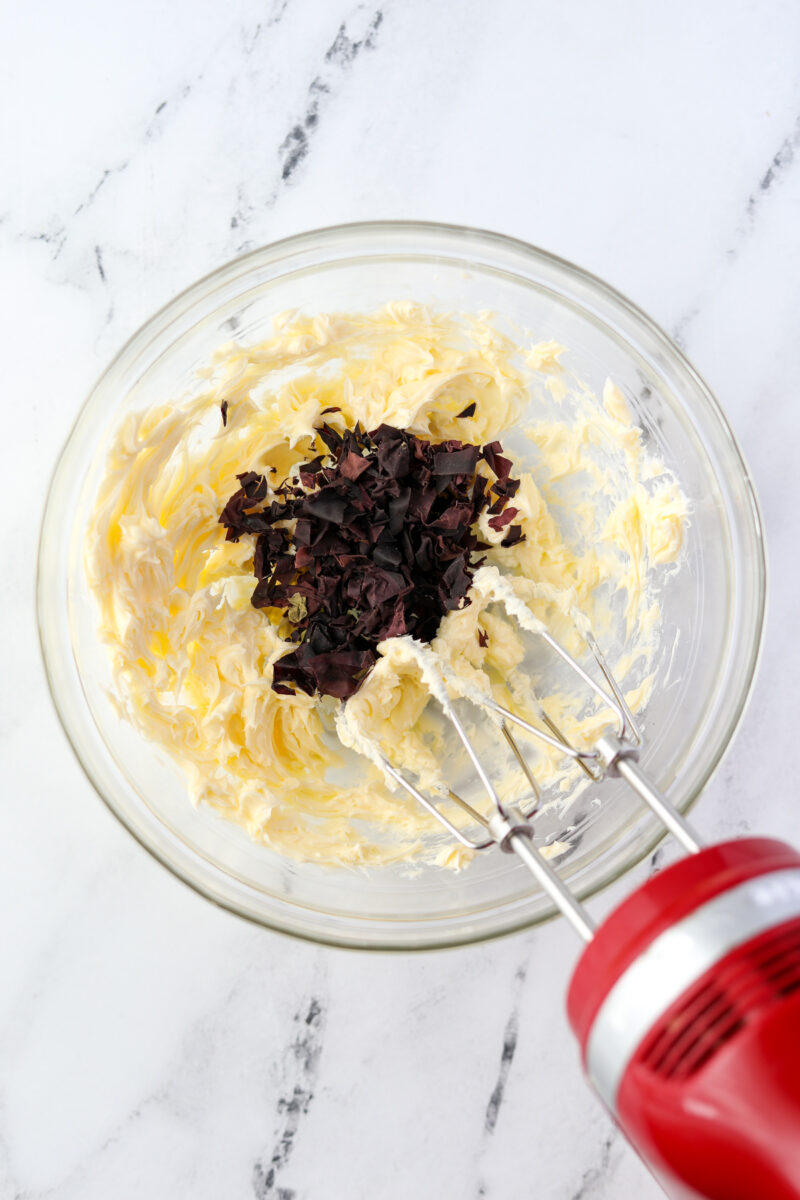 A bowl of butter with crushed seaweed added.