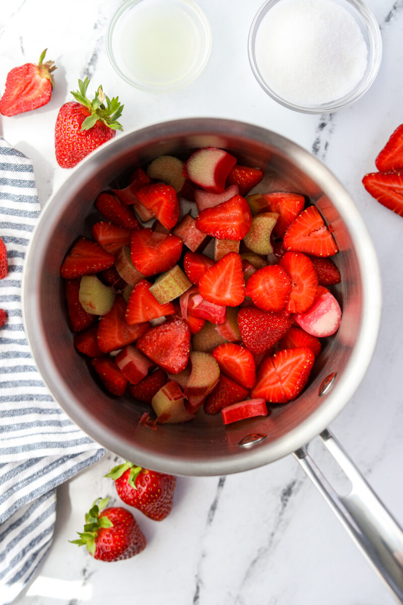 A saucepan filled with prepared strawberries and rhubarb.