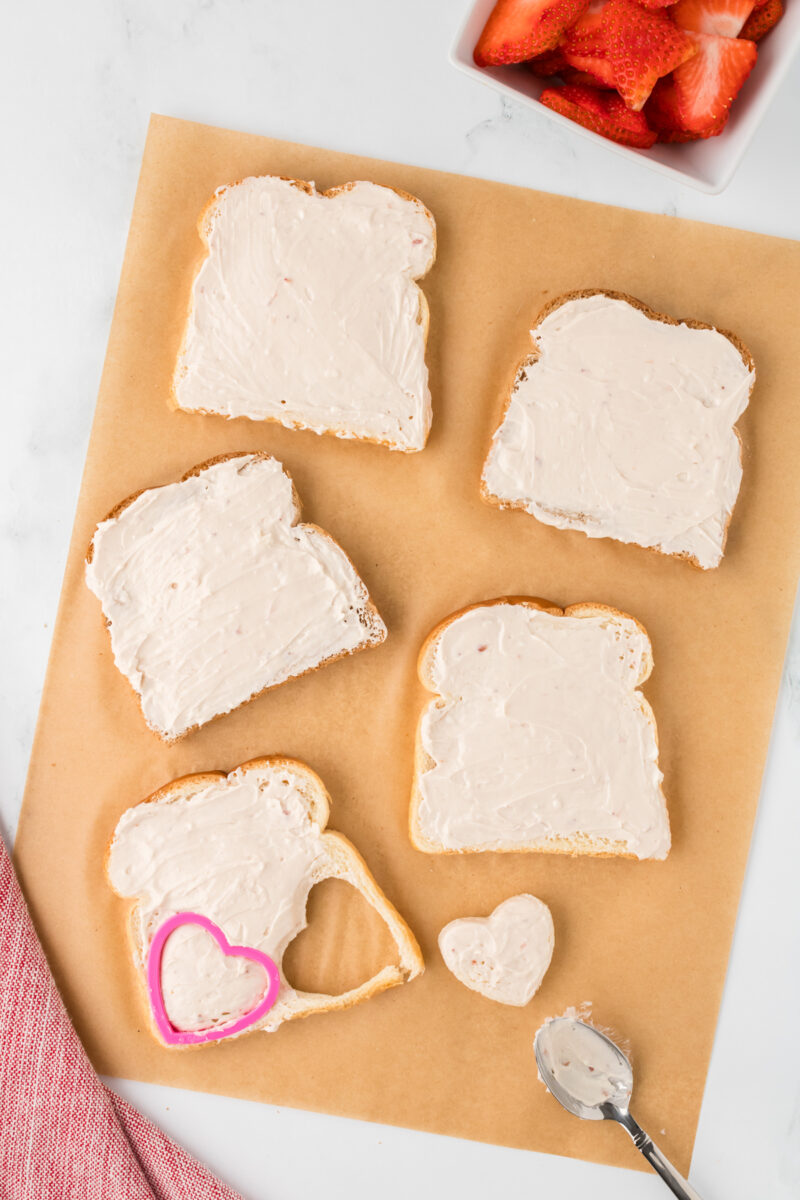 Slices of bread topped with cream cheese.