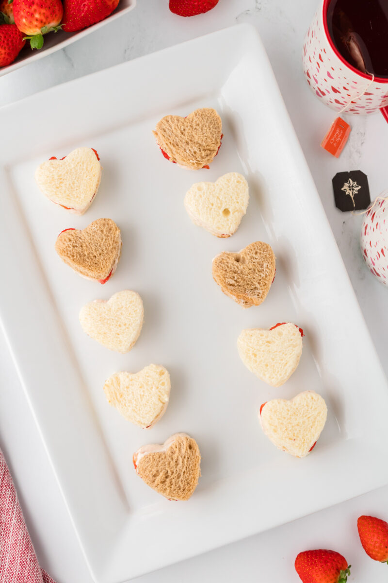 A platter filled with heart-shaped sandwiches.