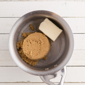 A saucepan with brown sugar and butter.