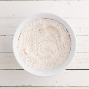 Flour and other dry ingredients mixed together in a bowl.